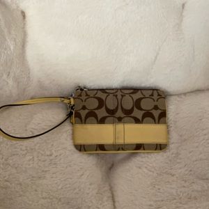 Coach wristlet. New Never used.yellow and tan